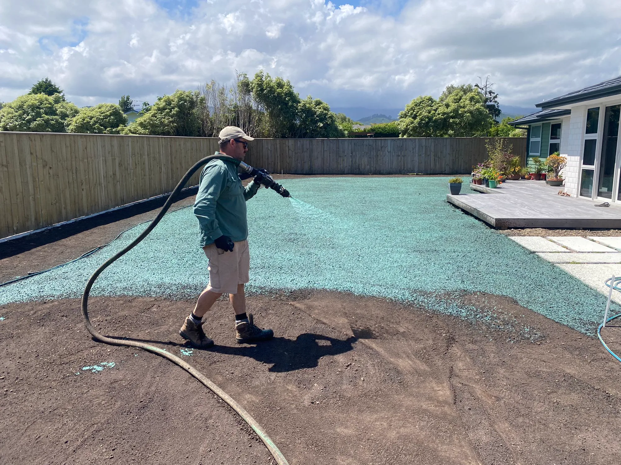 Technician hydroseeding a lawn
